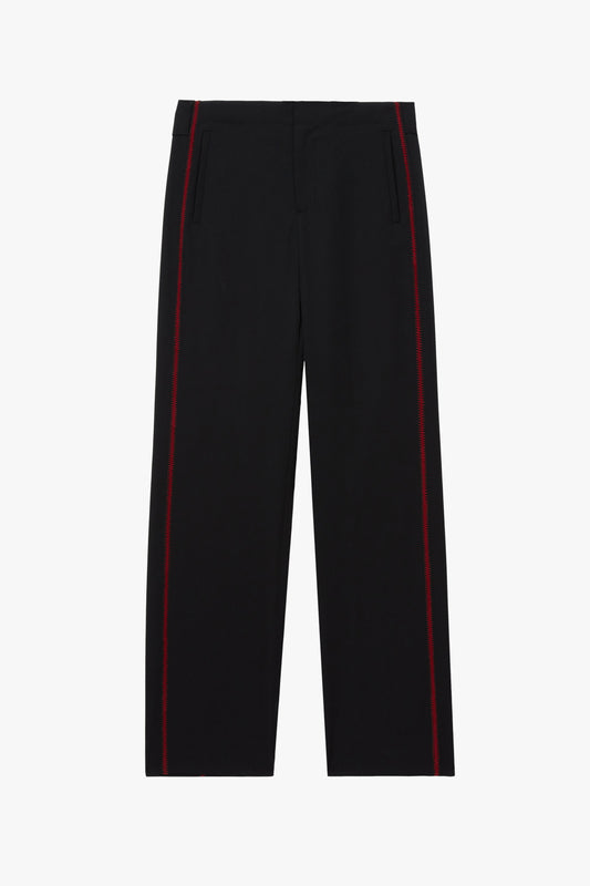 A pair of trousers photographed against a plain white studio background. The black trousers have red stitching details on the side.
