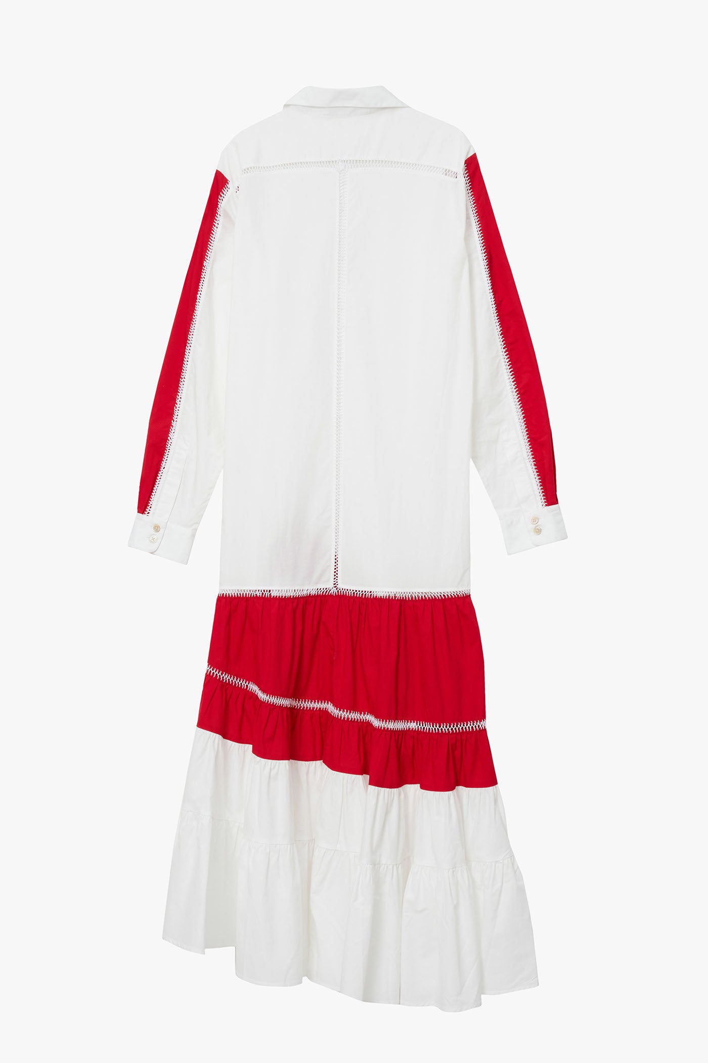 White shirt dress  with asymmetric red and white ruffle panels at hem and on sleeves. Photographed on a white background. 