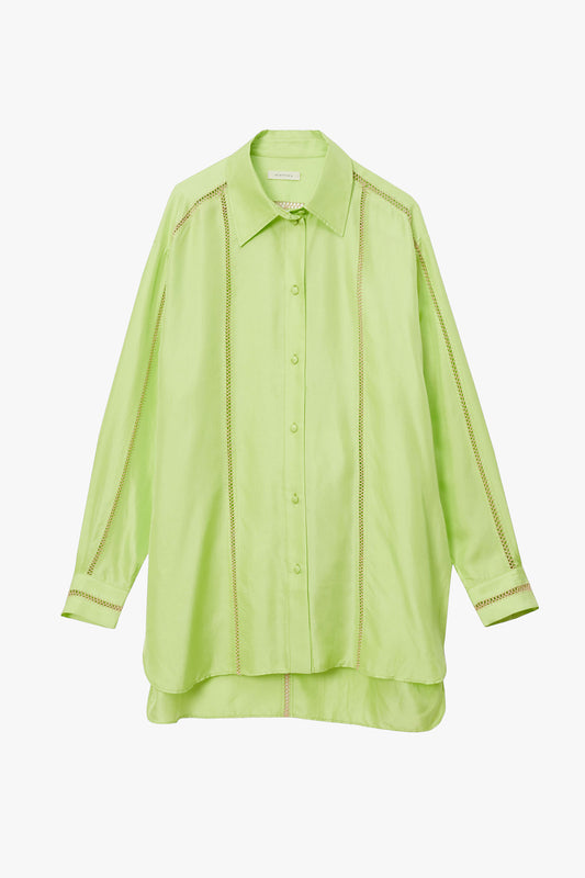 Lime green silk shirt with stripes of beige hand stitched detailing along sleeves, down the chest, and in a T along the back. Photographed on a white background.