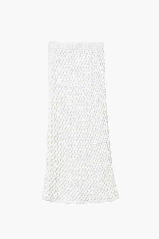 White knitted chunky crystal embellished straight skirt on a white background. 