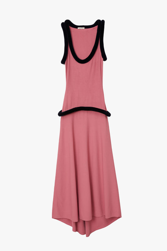 Pink flat knit tank dress with marine blue sculptural tubing at sleeve and neck holes as well as along the hips. Photographed on a white background. 