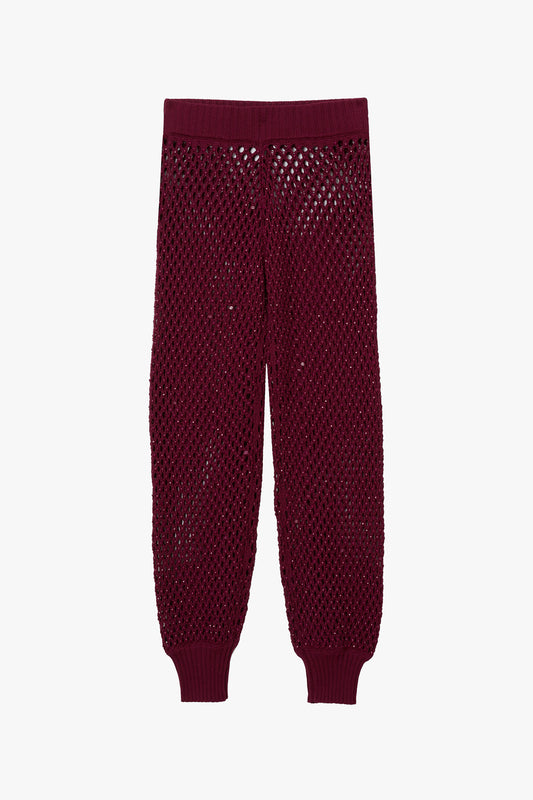 Magenta micro crystal embellished joggers on a white background.