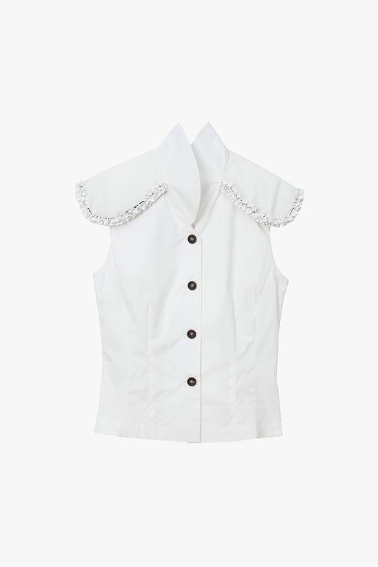 White sleeveless cotton vest with white paillette trim and high collar photographed on a white background.