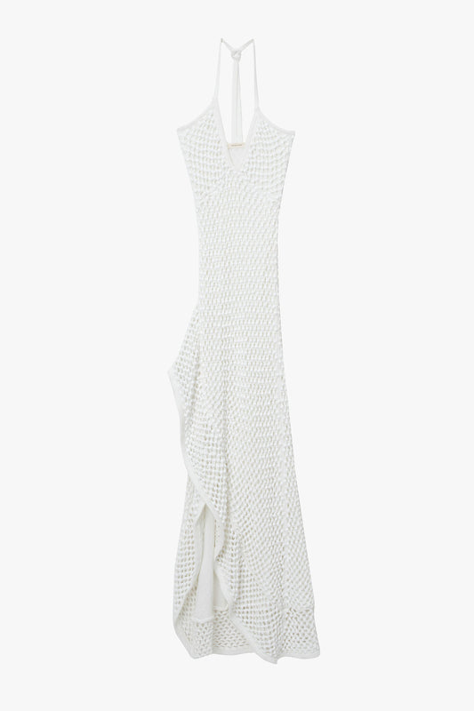 White chunky crystal embellished camisole dress with open back on a white background. Dress has high slit and ruffle hem. 