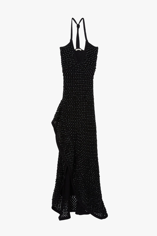 Black chunky crystal embellished camisole dress with open back on a white background. Dress has high slit and ruffle hem. 