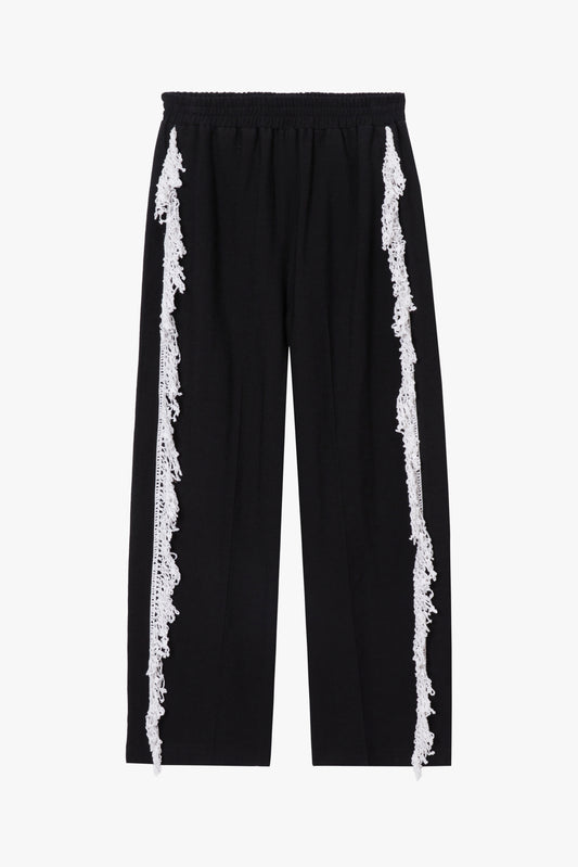 Black pants with white crochet trim on both legs on a white background