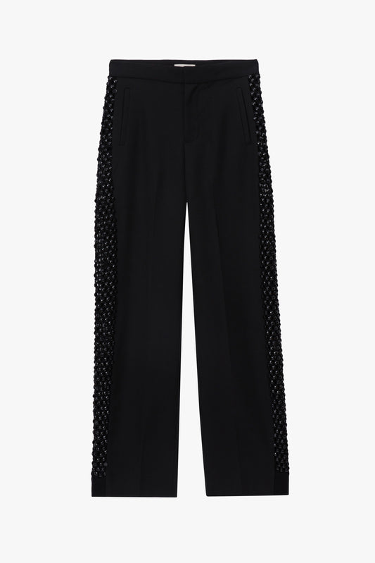 Black pants with textured side panels on a white background