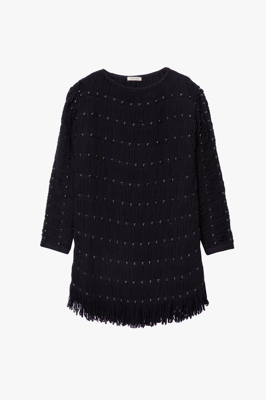 Black knit dress with fringe details on a white background