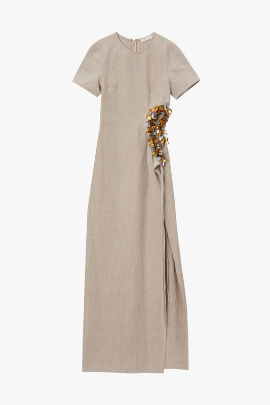 Beige dress with a waist cutout and paillette embellishments on a white background
