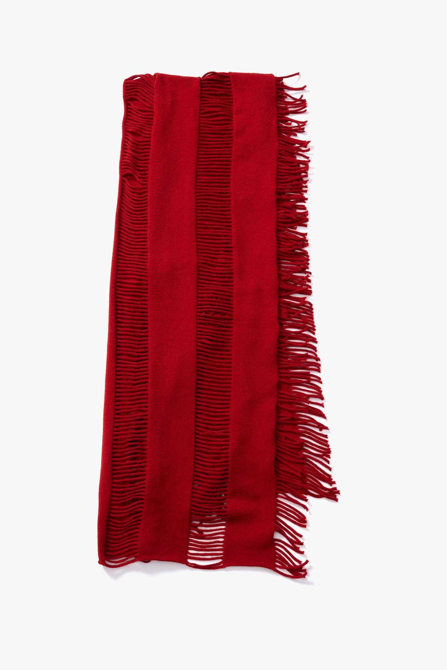 A coral red scarf with fringed edges, laid flat against a white background.