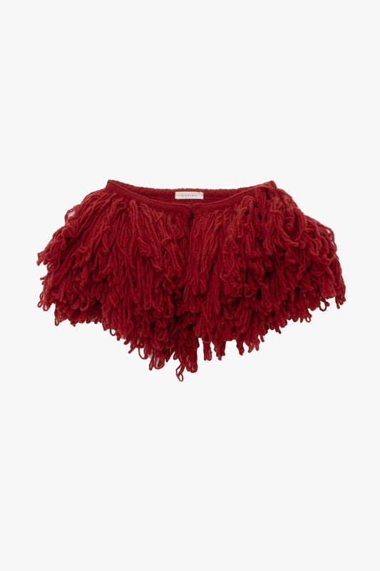 Image of an oversized wool red fringe collar on a white background.