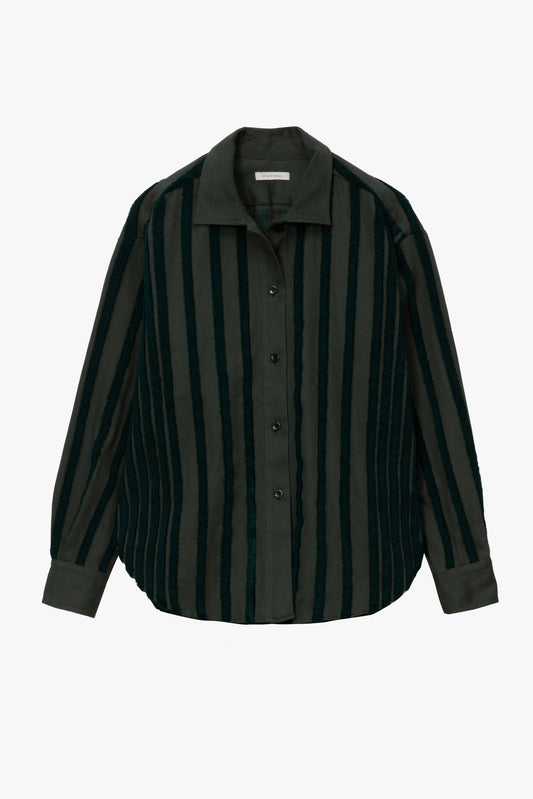 A long-sleeve button-up shirt with vertical stripes in dark olive green and black, featuring a pointed collar and dark buttons, shown against a plain light gray background.