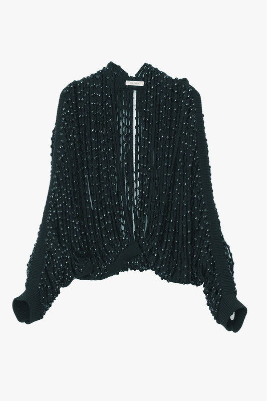 A black long-sleeve shrug featuring a textured, beaded, fringe design, shown against a plain white background.