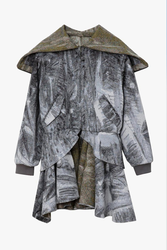 A long-sleeved, asymmetrical draped coat featuring a multi-color print, with a contrasting inner lining and hood. Displayed against a white background.