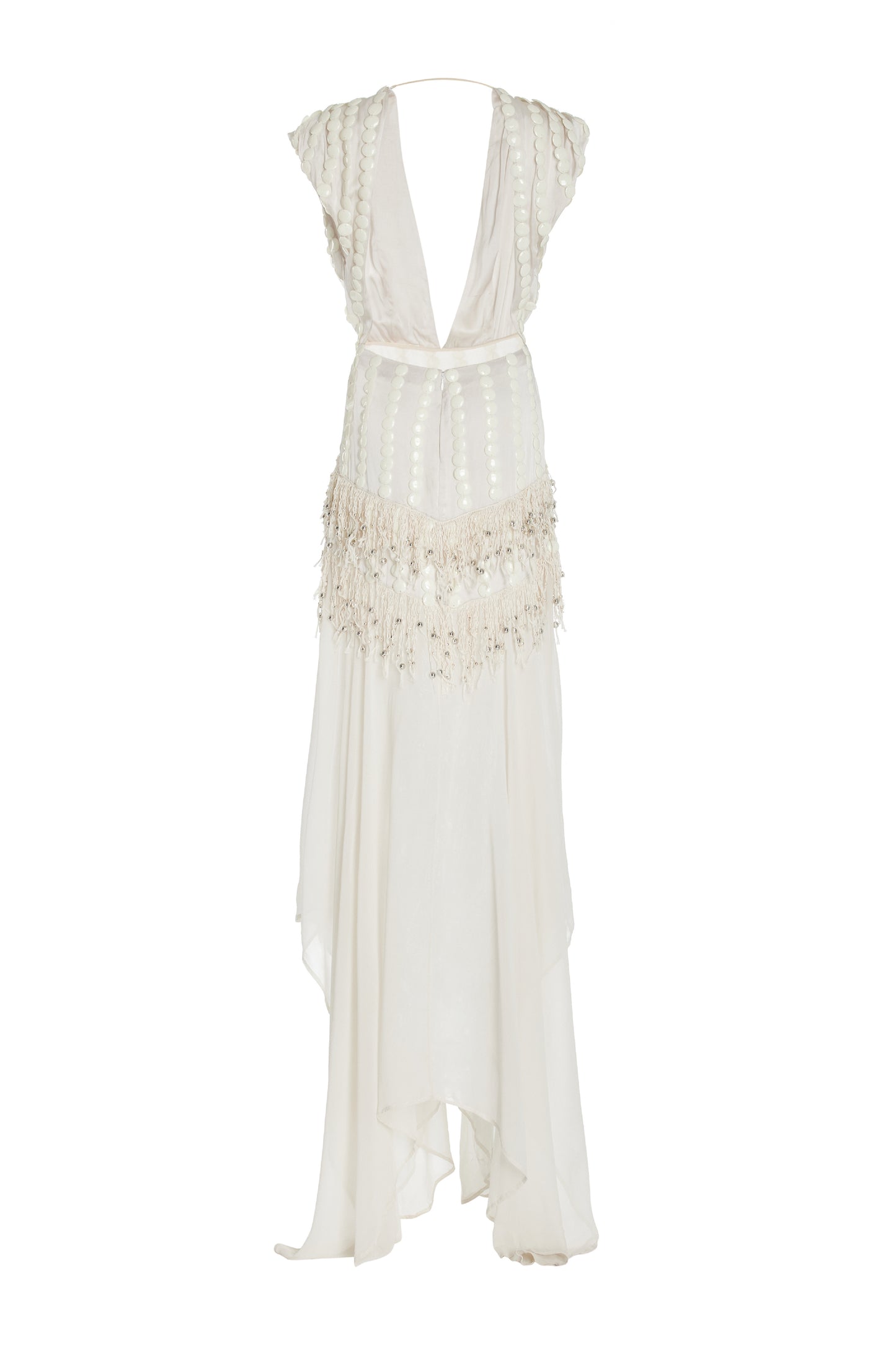 White dress with deep cut out and embellishments going down the side. Fringe detailing in the middle and flowy  skirt photographed against a white background. 